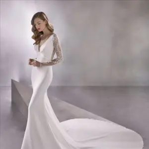 Pronovias Atelier Space Girl Wedding Dress - Mermaid style in crepe fabric with an elegant V-neckline bust and lace adorning the illusion sleeves and back.