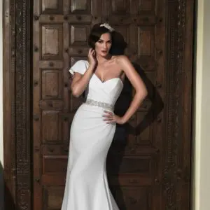 Suzanne Neville Spellbound Wedding Dress Sample Sale - A Line italian crepe dress with one shoulder, ruched fitted bodice, beaded sash, and puddle train.