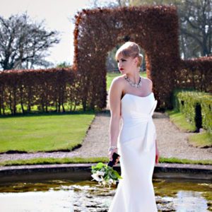 Suzanne Neville Harmony Wedding Dress Sample Sale - A Line strapless sweetheart neckline dress with silk crepe fitted bodice and pleated bow on hip.
