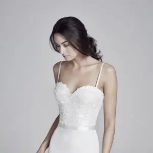 Suzanne Neville Bronte Wedding Dress - The sleek skirt and delicately detailed floral applique bodice of Bronte are beautifully balanced by its sweetheart neckline and elegant straps. This composition creates an ethereal yet sophisticated garment.