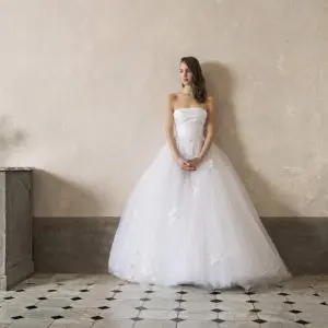 Peter Langner Daisy Wedding Dress - Strapless ball gown dress with fitted bodice, draped bustier in silk faille and 3D flowers embroidered on skirt.