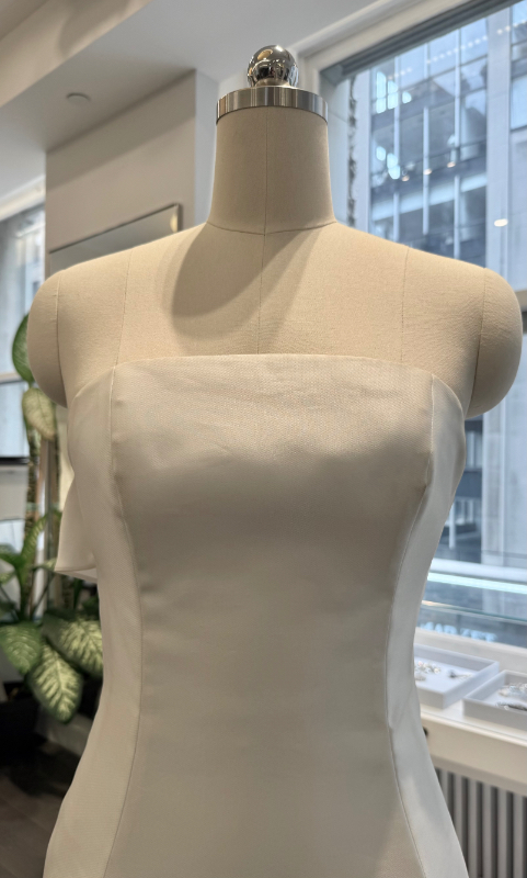 Allison Webb Baxley Wedding Dress - Snow mikado A-line gown with crescent neckline, and origami half bow, and chapel train. Optional pearl illusion halter.