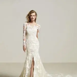 Pronovias Driate Wedding Dress Sample Sale - Mermaid dress with Illusion neck, long sleeves, semi sweetheart neckline, and front split in skirt with train.