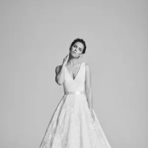 Suzanne Neville Ritz-Rosa Wedding Dress - A Line style dress with a deep v-neckline, Floral printed organza detail, and a satin belt.