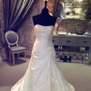 Suzanne Neville Ascuitto Wedding Dress Sample Sale - Mermaid style dress with beaded sweetheart neckline, fitted bodice, and detail in hip.