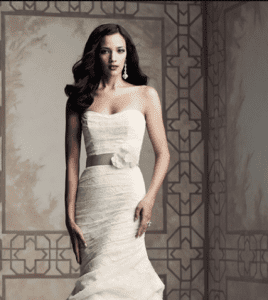 Paloma Blanca 4365 Wedding Dress Sample Sale - Strapless lace dress with tunic bodic, ribbon, flower detail at waist, cascade lace skirt and stunning sweep Train.
