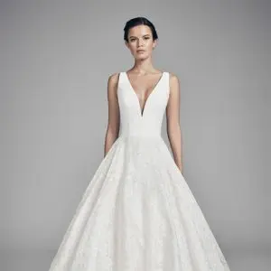 Suzanne Neville Swan Wedding Dres - Italian matte crepe gall gown with a Serrano fitted bodice, a deep plunging v-neckline and a rosa printed organza skirt.