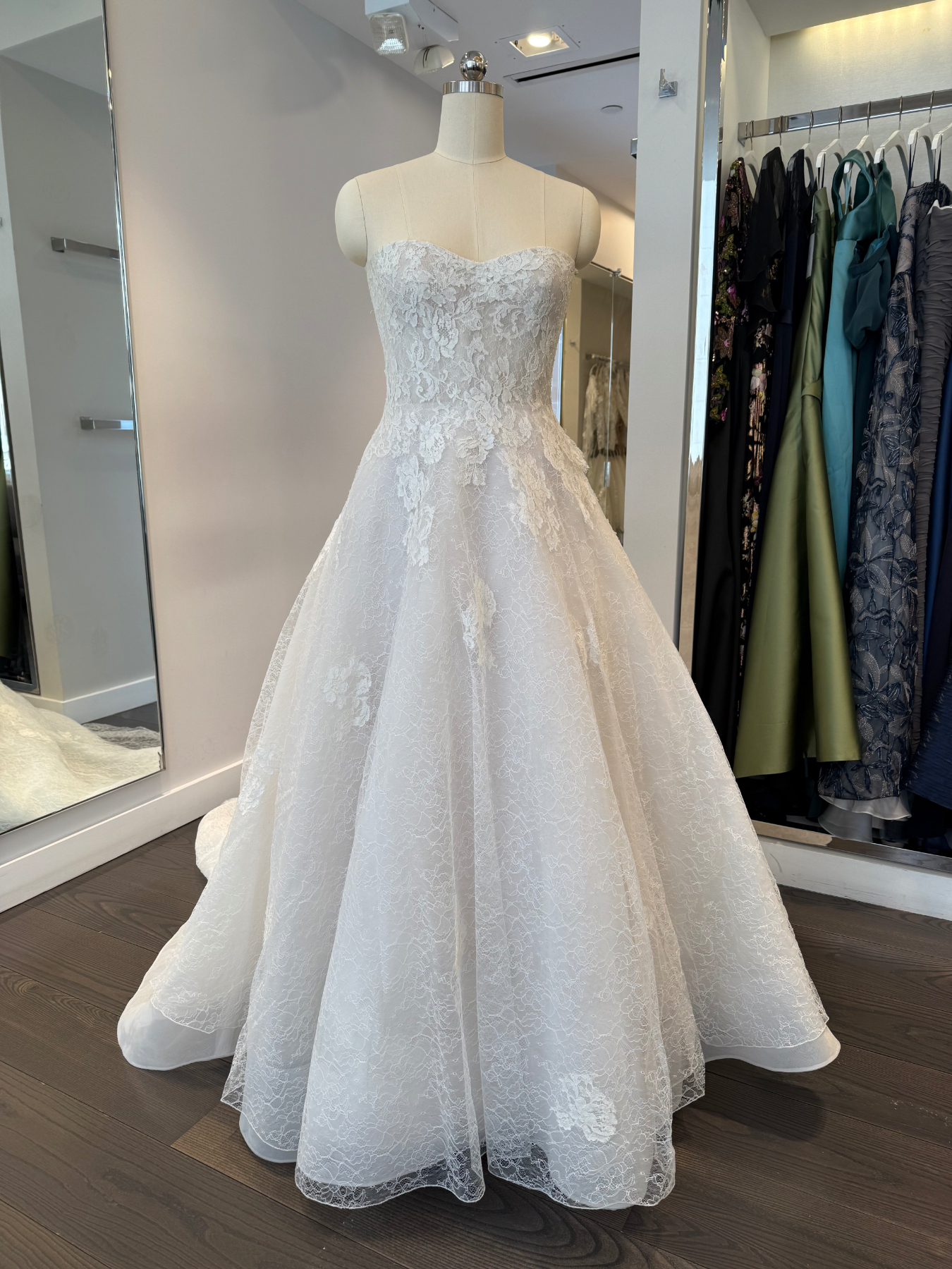 Allison Webb Sutton Wedding Dress - A-line gown with Ivory French lace layered over Cashmere lining, appliques on the skirt, molded bodice and chapel train.