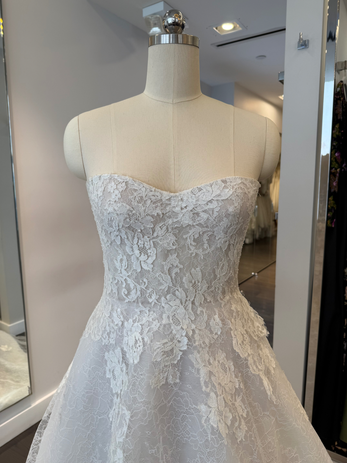 Allison Webb Sutton Wedding Dress - A-line gown with Ivory French lace layered over Cashmere lining, appliqués on the skirt, molded bodice and chapel train.