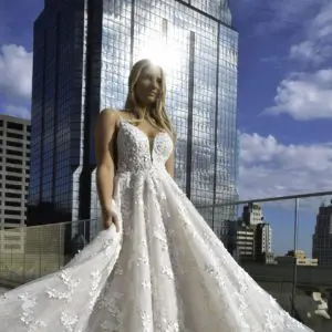 Martina Liana 1325 Wedding Dress - A-line plunging V neckline, side cutouts, Chantilly French lace, 3d tulle floral detail and rounded train. 