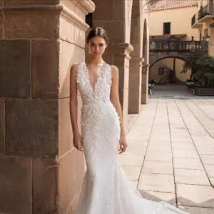 Pronovias Aethra Wedding Dress - Mermaid gown with 3D flowers along the deep v-neckline that gather at the waist and cascade down the skirt.