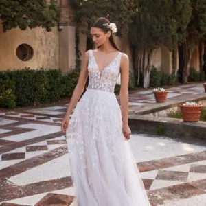 Pronovias Elara Wedding Dress - Thin vines with floating leaves trace the straps, V-neckline, illusion bodice, and tulle skirt of this sheath gown.