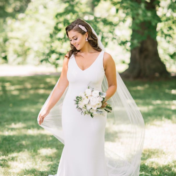 Caralyn & Miranda Wedding Atelier Real Bride - Martina Liana 685 Wedding Dress Sample Sale – Simple Crepe sheath wedding dress with deep v- neckline, straps and open low back with Crepe-covered buttons accent train.