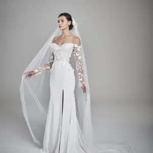 Suzanne Neville Eden Wedding Dress - Elegant sheath dress with long sleeves, sweetheart neckline, featuring 3-D floral appliqué with center slit.
