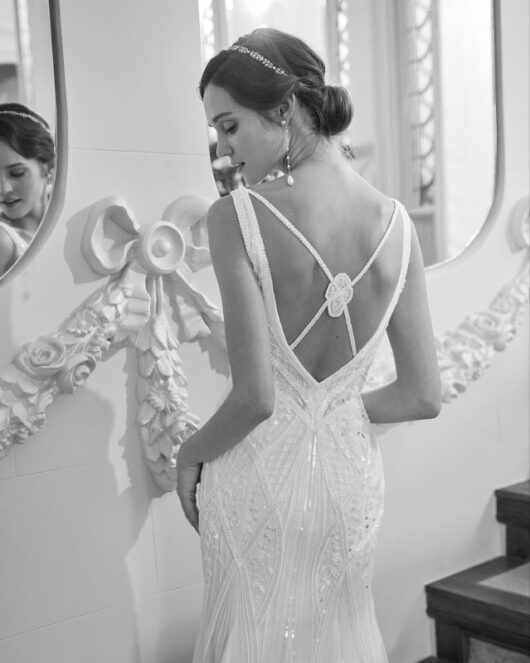 Rosa Clara Collection Quiric Wedding Dress - Modern dress with straight silhouette, plunging neckline, straps and open back. Criss-cross back and rhinestones.