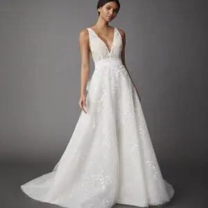 Allison Webb Lillia Wedding Dress - Sheer plunging V-neck A-line gown with delicate floral embellishments over sparkle dotted tulle and a tulle sash.