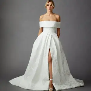 Allison Webb Aubrey Wedding Dress - Italian Snow Floral Jacquard A-line gown with pearl trim at neckline, slit skirt, and buttons to the end of the train