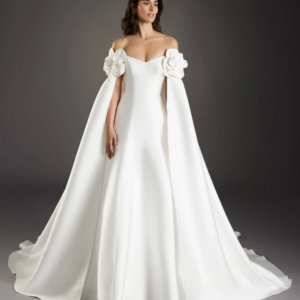 Pronovias Sagrada Wedding Dress - Fit and flare style dress with a strapless v-neckline, open back, covered buttons throughout the skirt and cape.