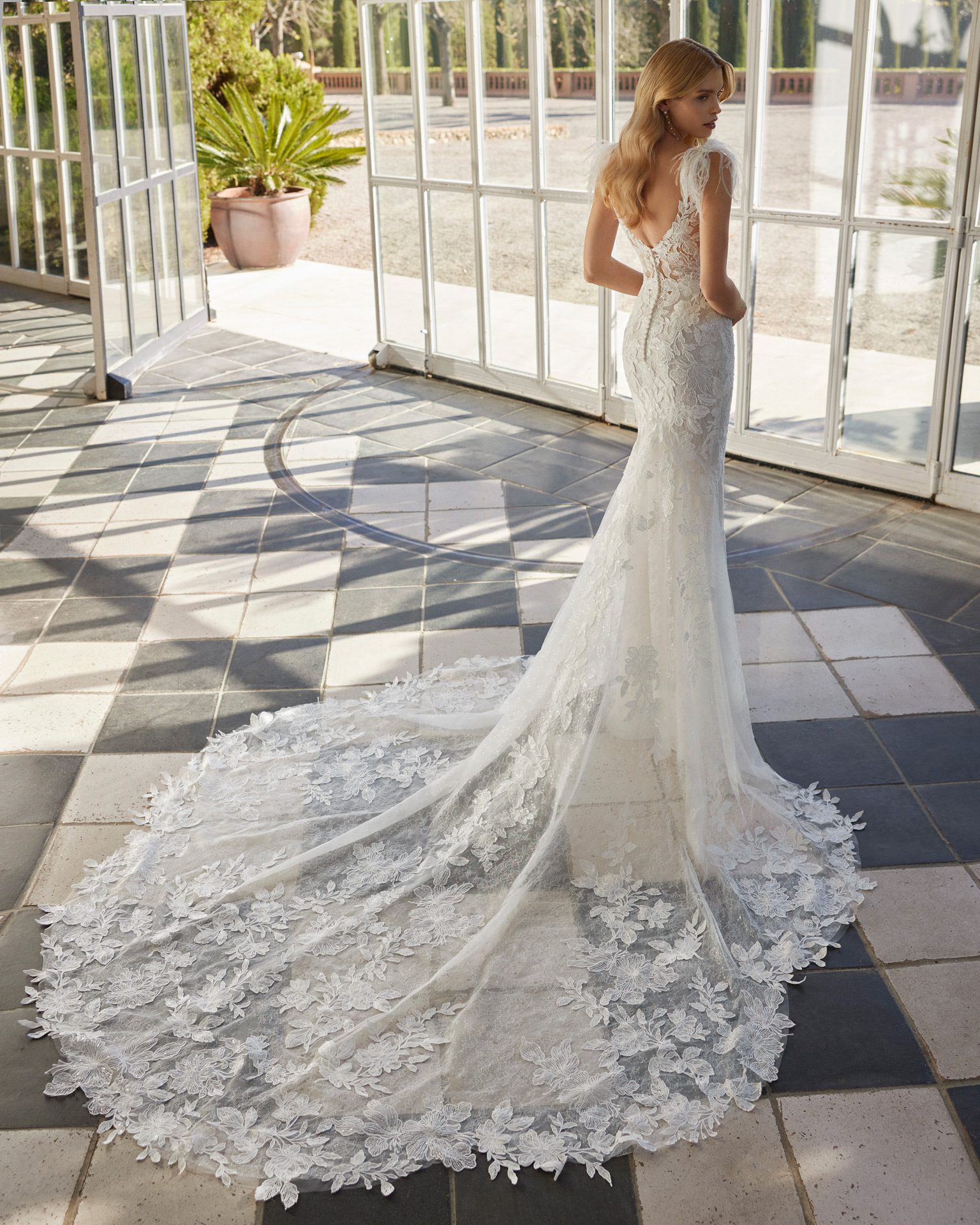 Rosa Clará Vaveri Wedding Dress - Fit and flare style dress with floral beaded lace, deep plunge v neckline, feather on shoulders detail and train.
