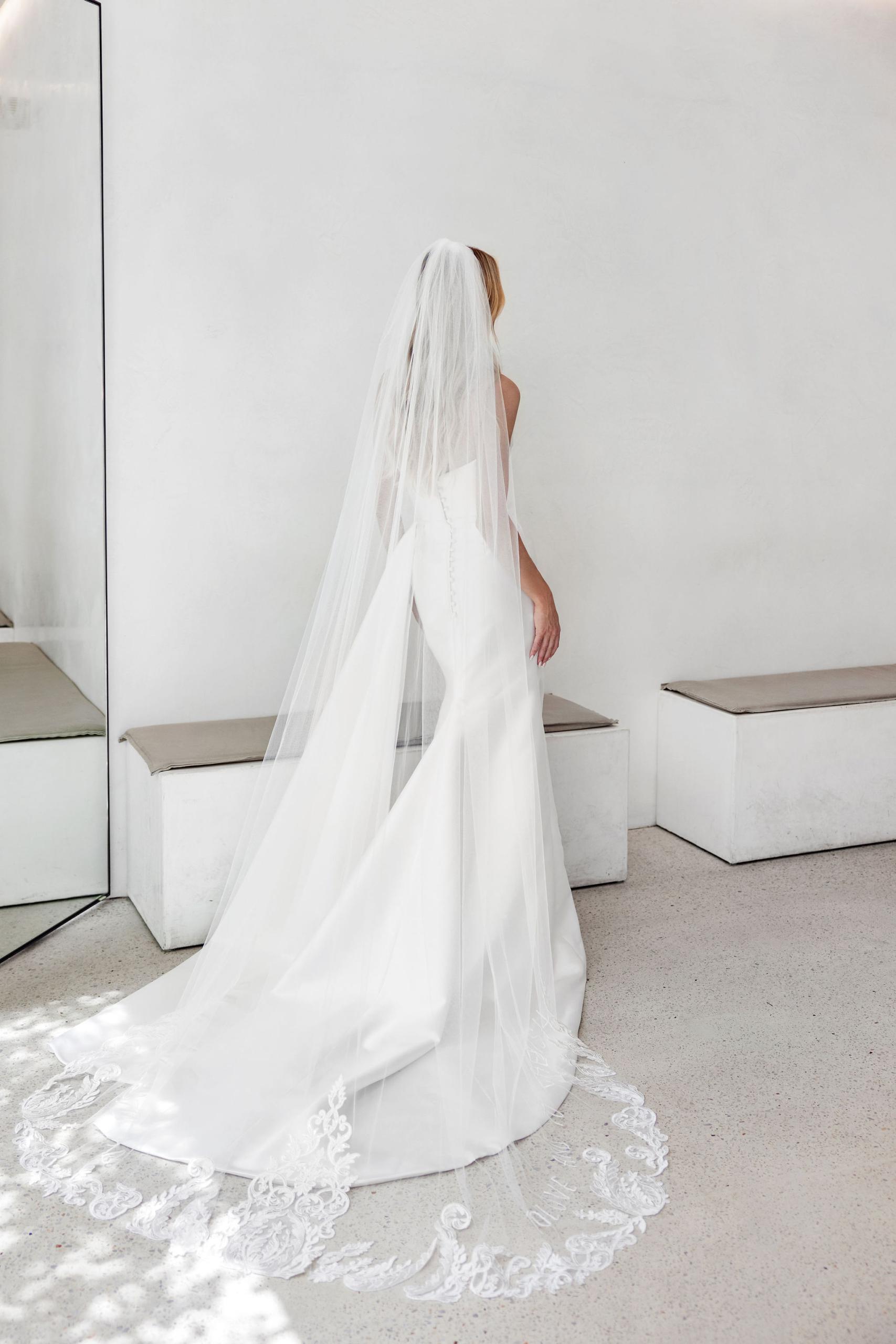 Mariana Hardwick Amelia Wedding Dress - Draped gown with cinched waist and wrap split with dramatic hip train detail in Italian silk mikado.