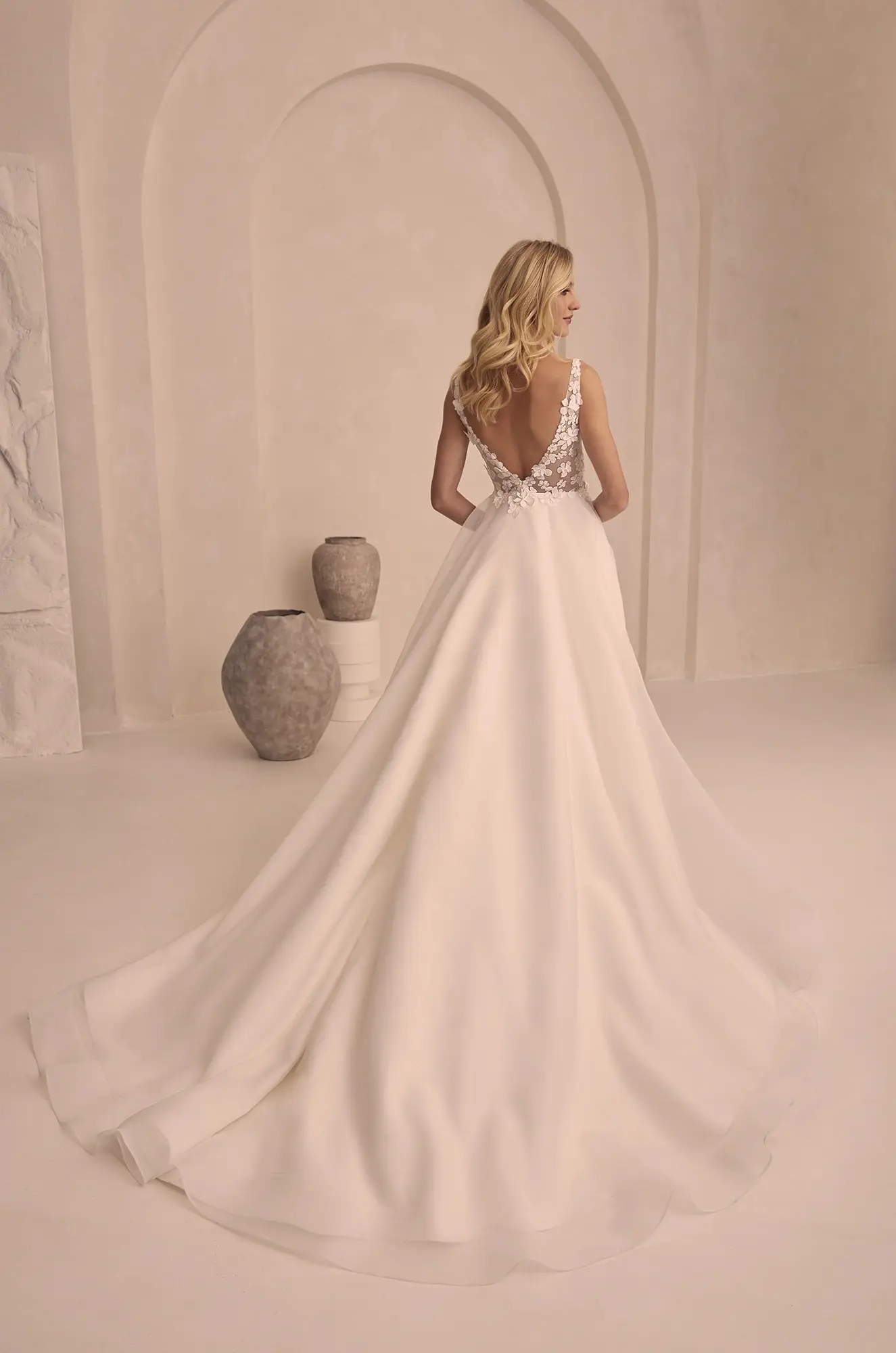 Paloma Blanca m2516 Wedding Dress - A Line plunging neckline, V-Neckline, bow, front skirt slit, and 3D Flowers in lace and organza.