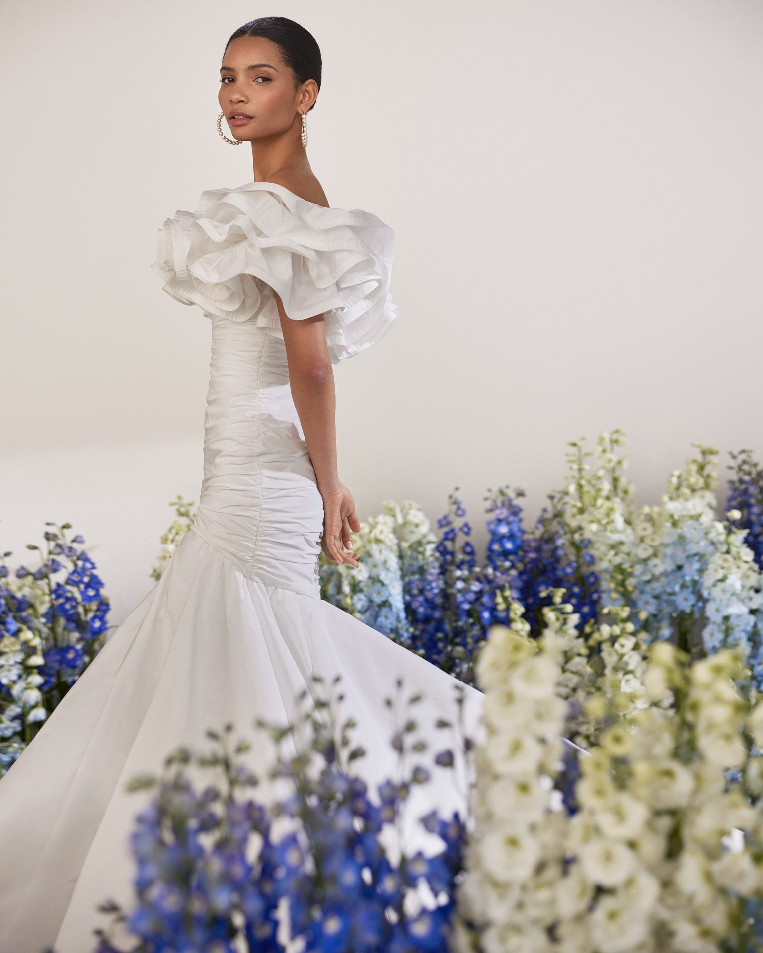 Rosa Clará Tanger Wedding Dress - Sexy mermaid wedding dress made in taffeta. Featuring a strapless neckline, flounced details and a draped bodice.