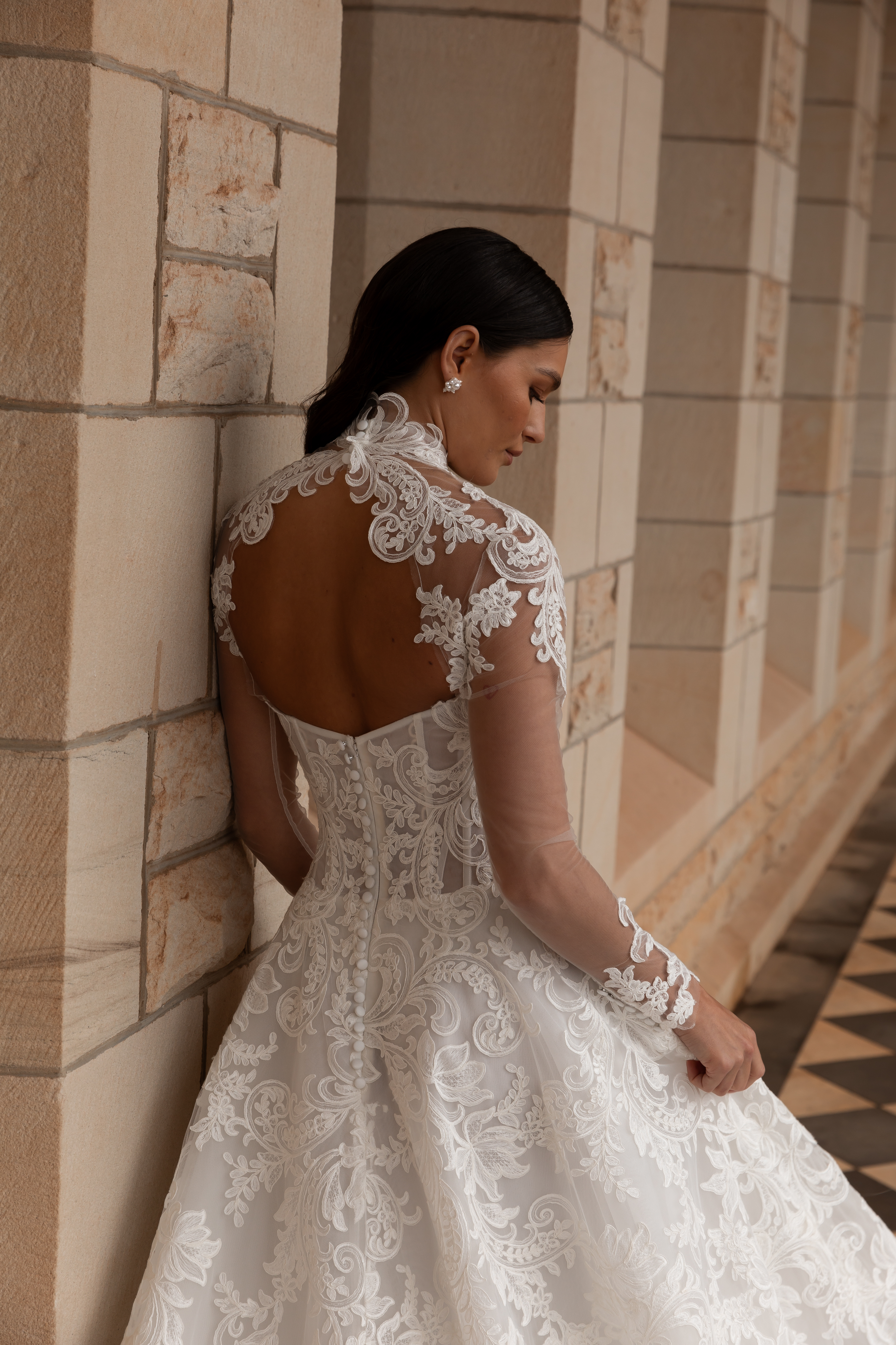 La Premiere Amber Wedding Dress - A-Line style dress featuring a chic cat-eye neckline, drop-waist design, full-cut corded lace and exposed boning.