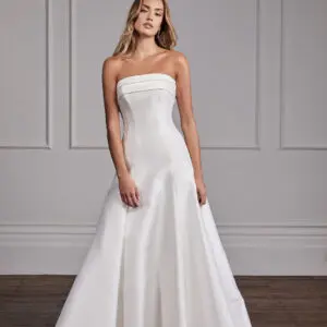 Suzanne Neville Grace Wedding Dress - Classic Modern Bridal Gown with Princess Seams, Straight Strapless Neckline, Corset, Draping Details in Satin Fabric.