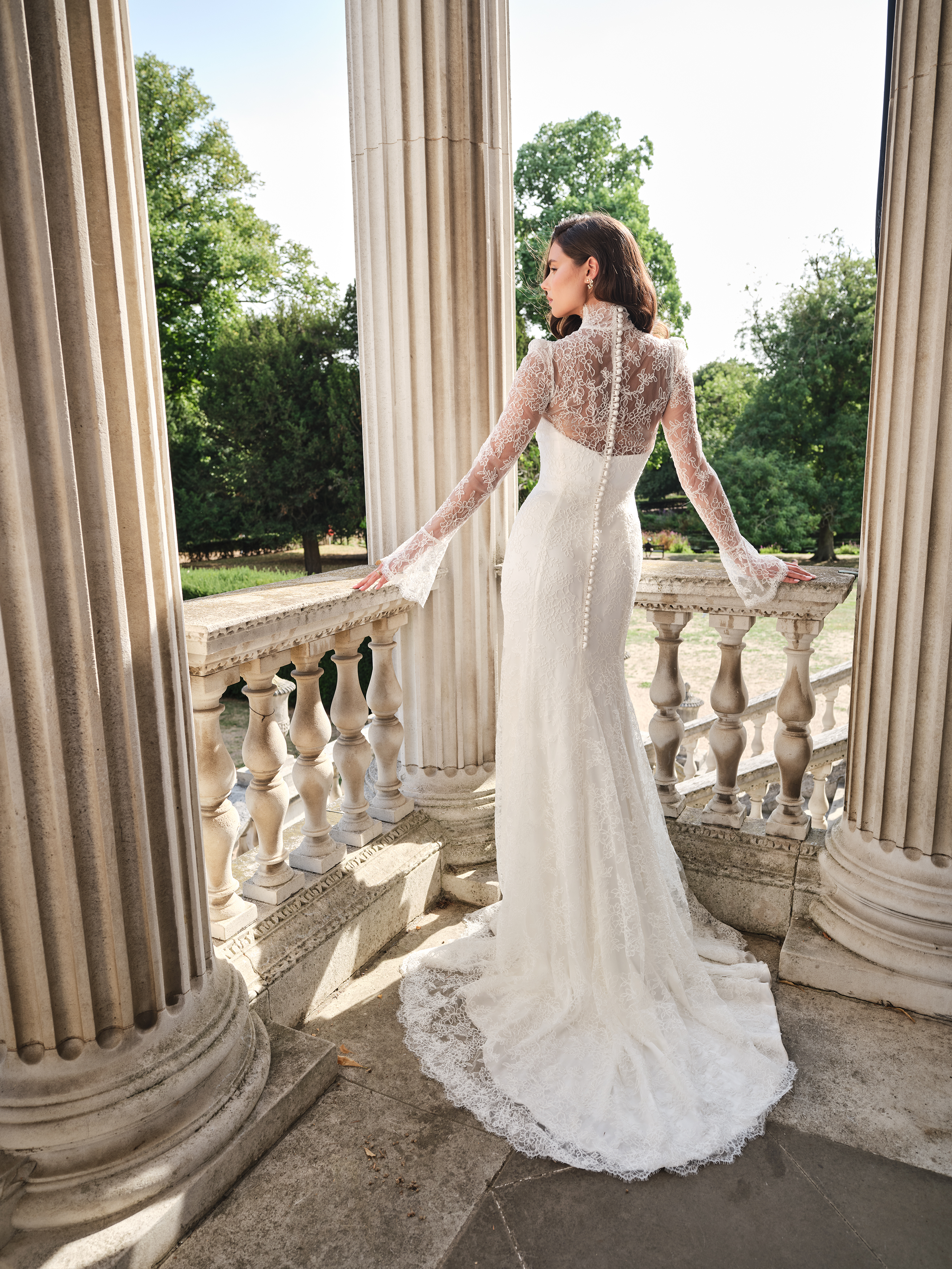 Suzanne Neville Aurora Wedding Dress - Romantic Modern Couture Fit and Flare Bridal Gown with Natural Waist, High Neck, Long Sleeves, Corset and Train Details and Lace Fabric