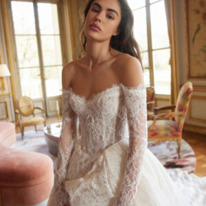 Netta Benshabu Emmanuelle Wedding Dress - Couture Modern Bridal Gown with Drop Basque Waist, Off the Shoulder V-Neckline, Detachable Long Sleeves and Lace Fabric.